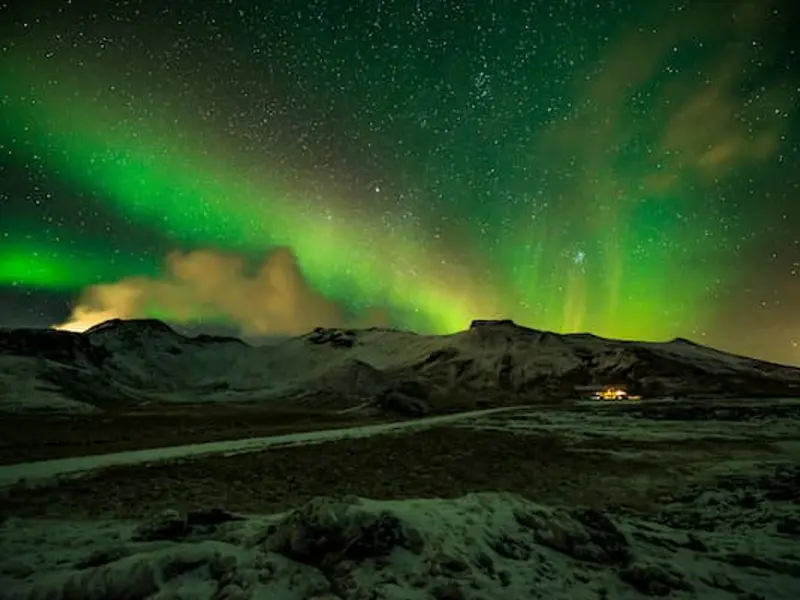 Northern lights above the mountain landscape near Hveradalir