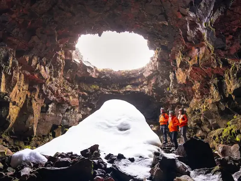 Visitors beneath an opening in a lava tube