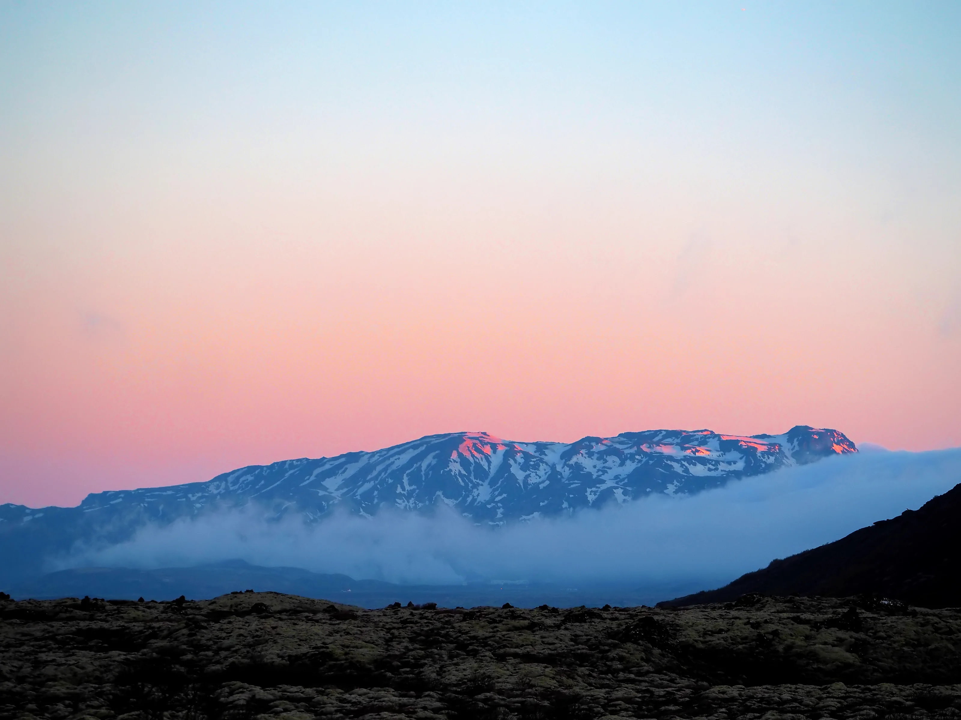 Snowy mountain ridges and clouds in the Hengill region